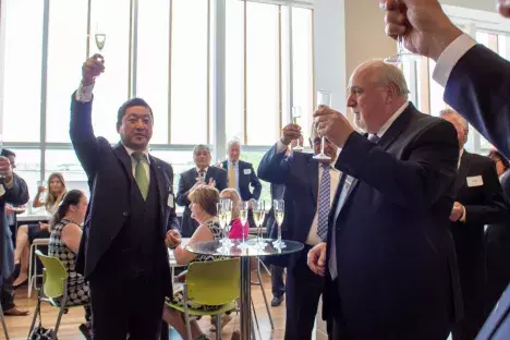 Photo of Champagne toast by Mayor Ryan of Alsip, IL and Dr. Nakao